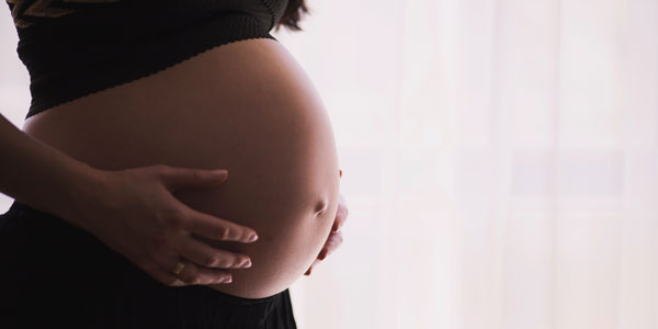 Generic image of African woman holding pregnant belly